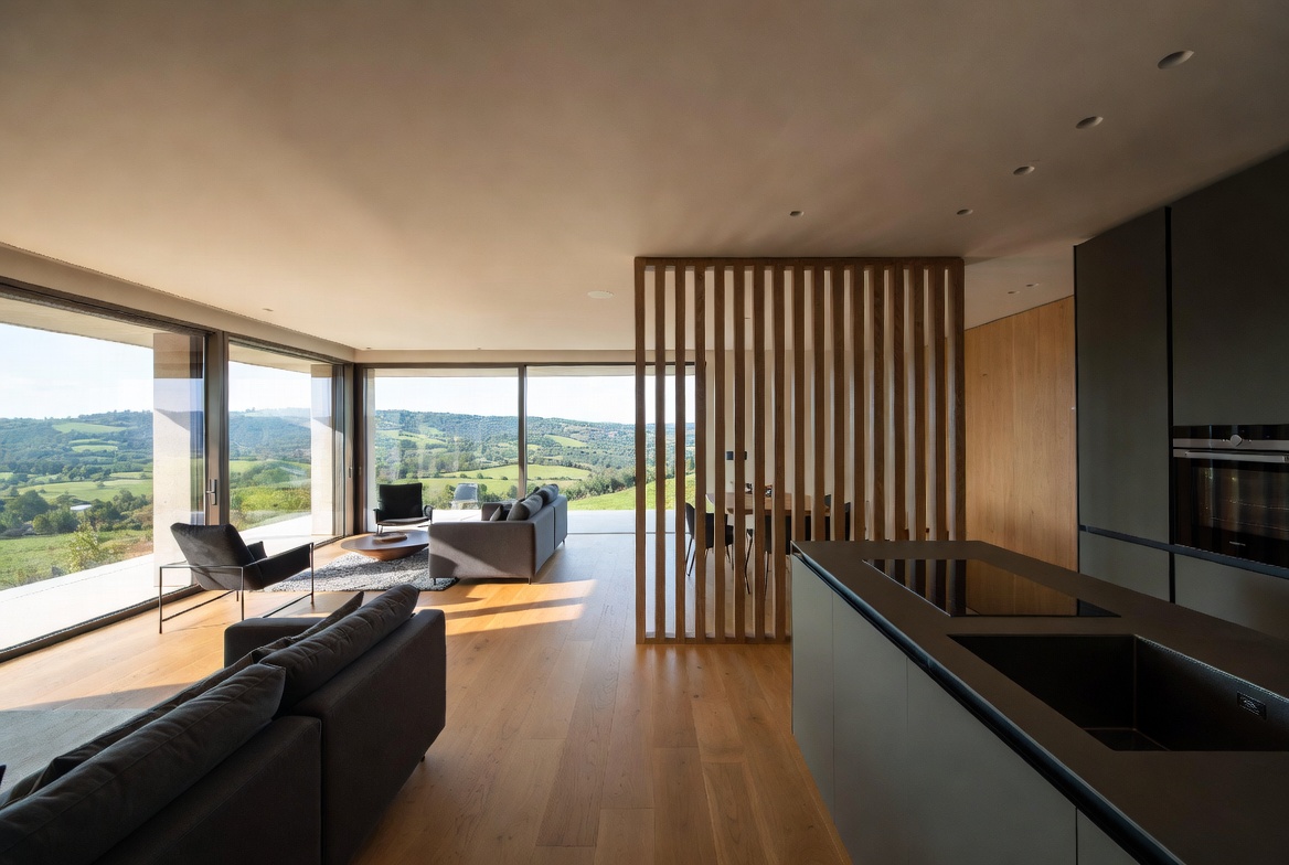 Open-plan living and kitchen with panoramic hill views